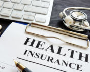 Individual health insurance policy and stethoscope.