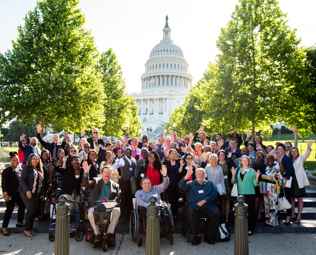 Group of kidney advocates waving in front of the Capitol building