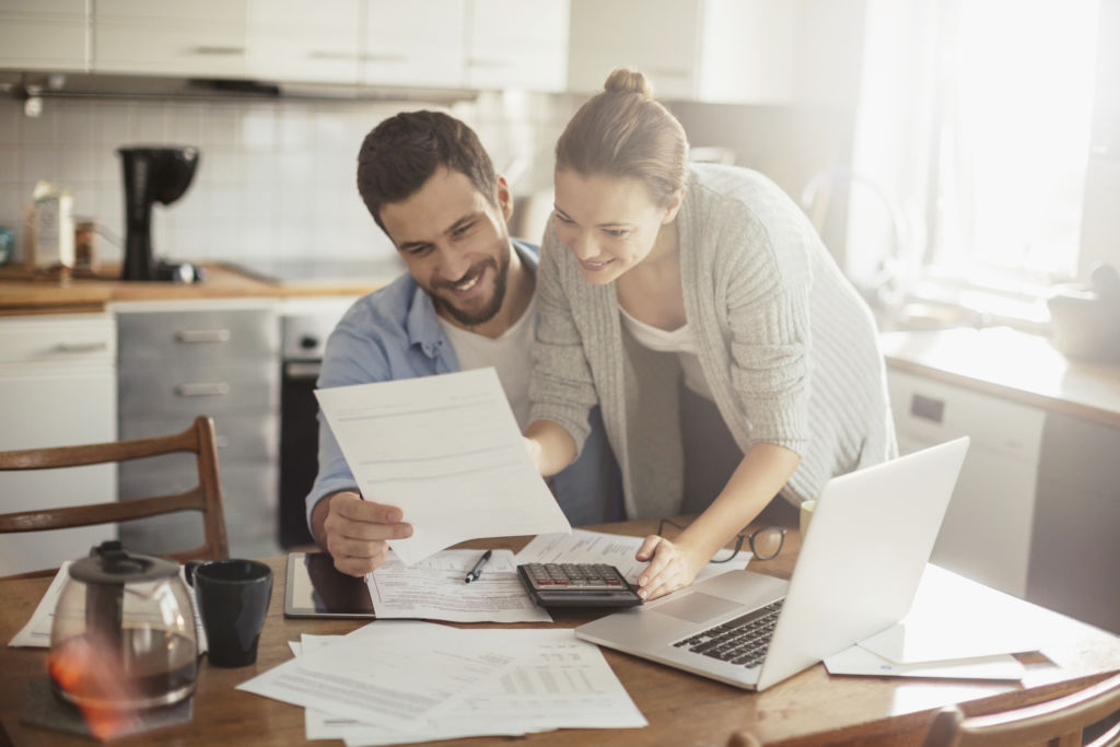 Photo of a young couple calculating home finances