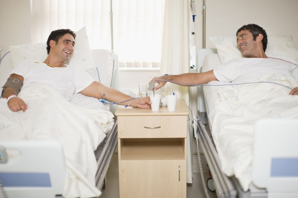 Patients talking in hospital beds