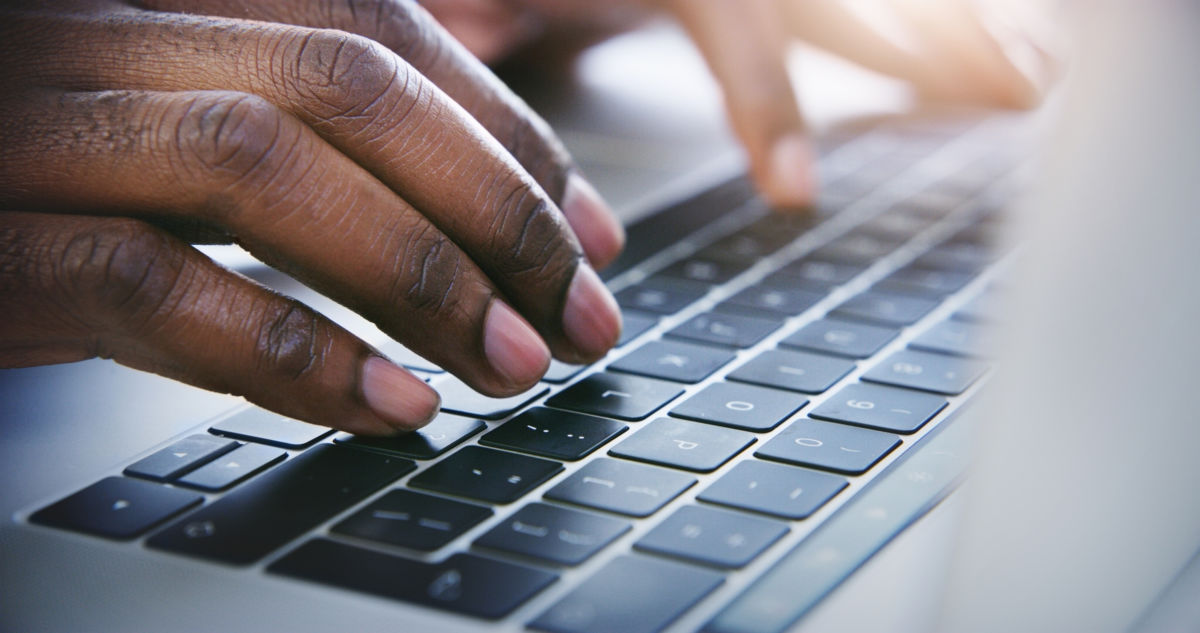 fingers typing on a keyboard