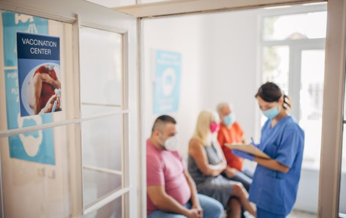 patients in waiting room, staffing shortage, not enough staff to assist patients